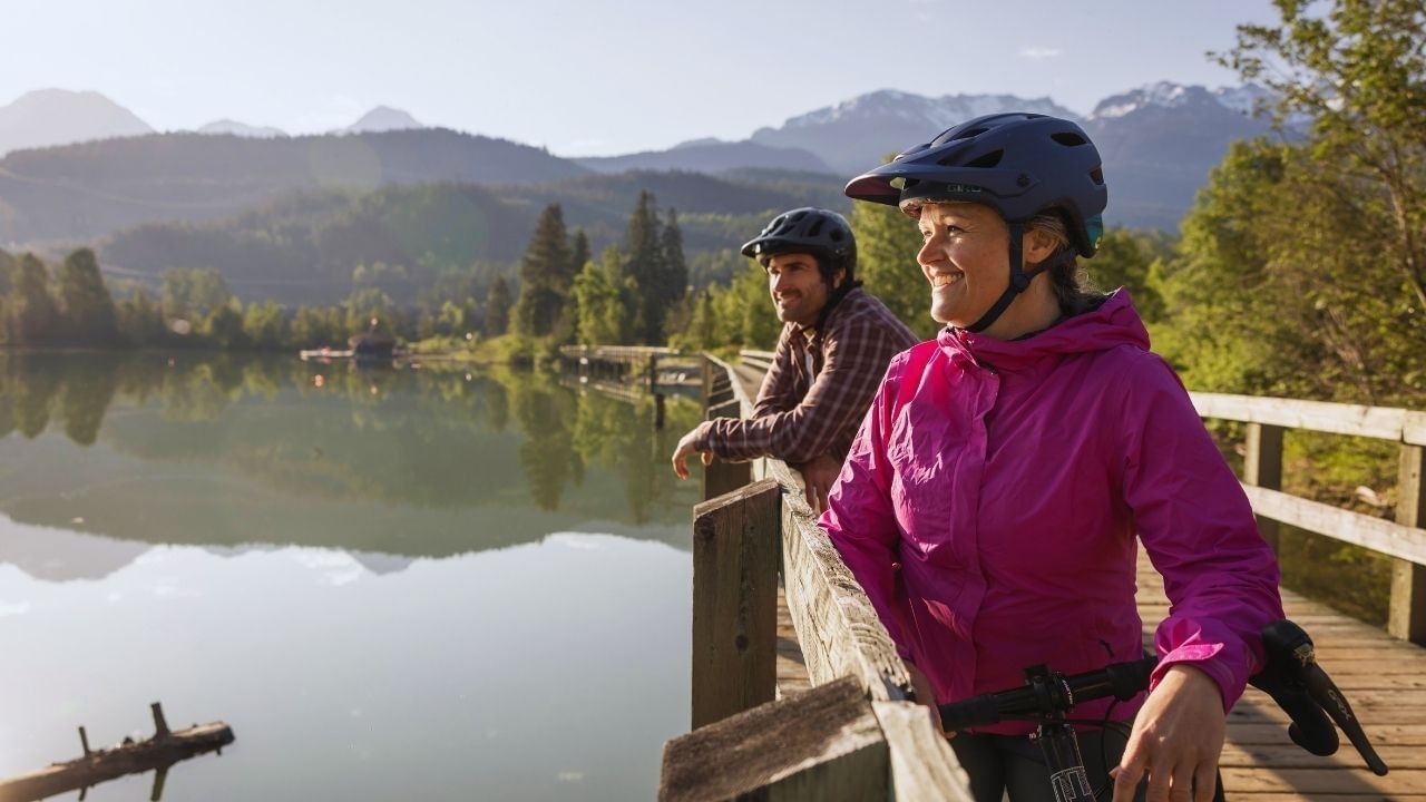 Cyclists by lake in Whistler in spring