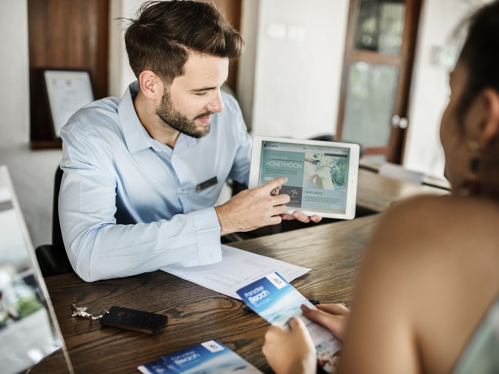 Man holding tablet showing offers at La Coleccion Resorts