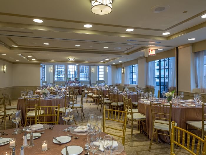 Elegantly set banquet tables near the window in Tip Top Tap Ballroom at Warwick Allerton Chicago