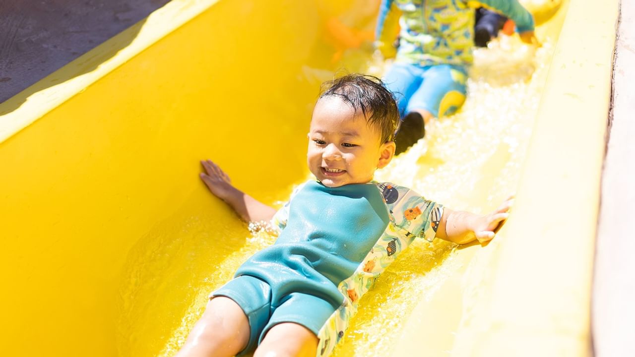 kids on a yellow waterslide