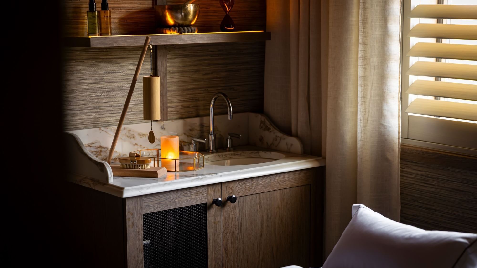 Cozy spa corner with marble sink, golden decor, candlelight glow, and relaxing atmosphere inside Dunluce Lodge