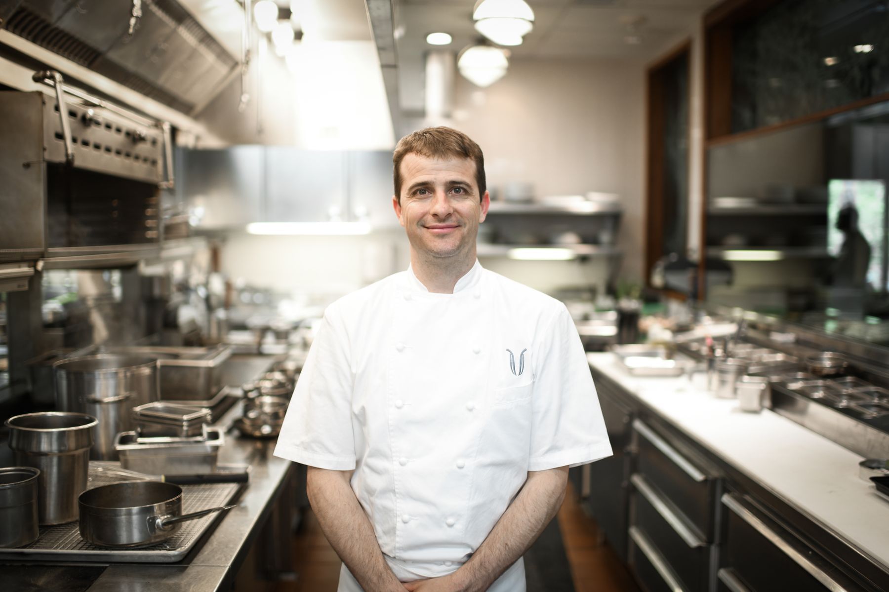 Chef Spencer Thomson in the kitchen posing for a photo at Umstead Hotel and Spa