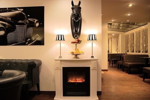 Table with fire place in dining room at Rhein Hotel St. Martin