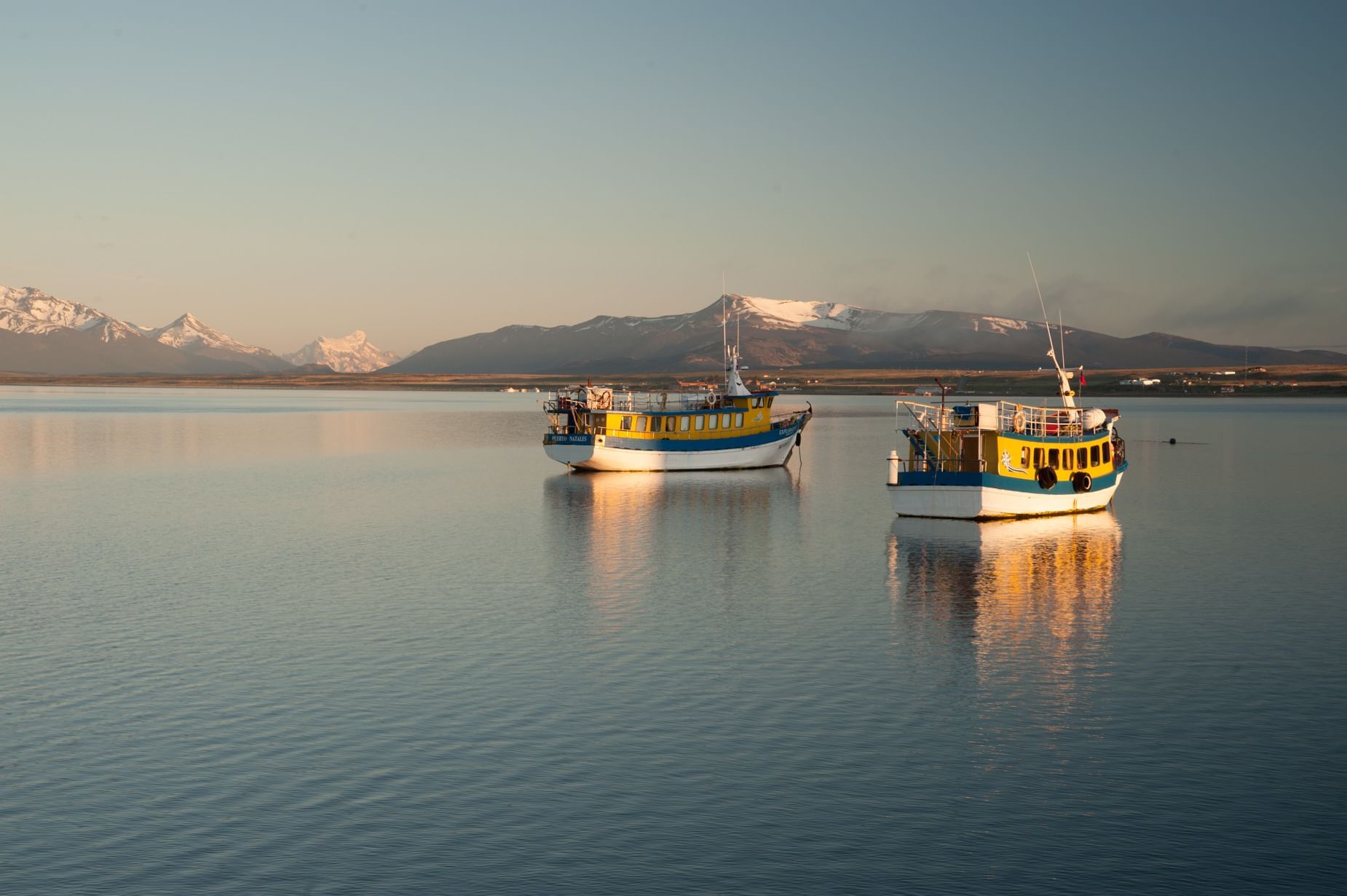 Two tourist boats in the sea near The Singular Patagonia