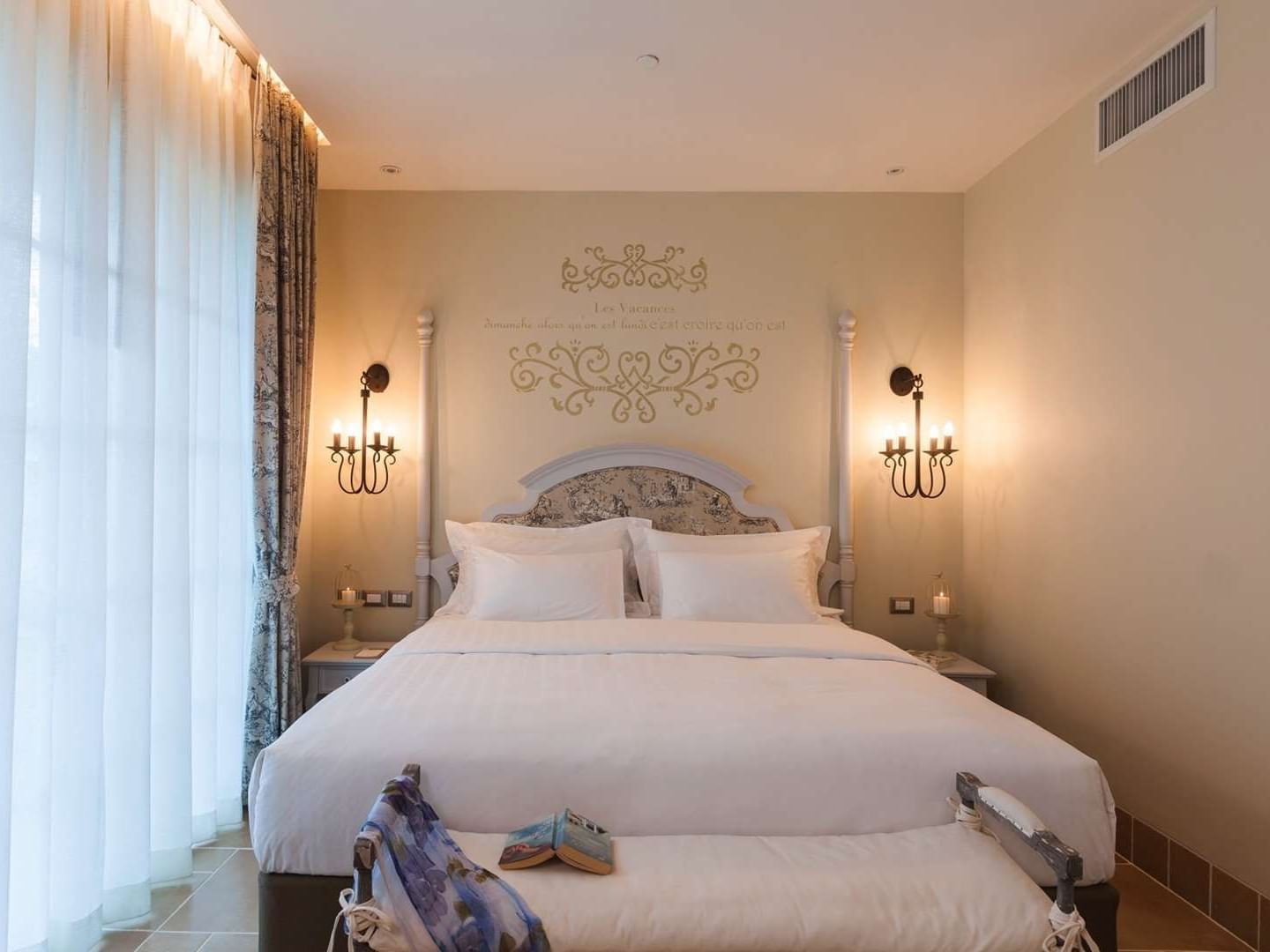 King-size bed and wall lamps in Suite at U Hotels and Resorts