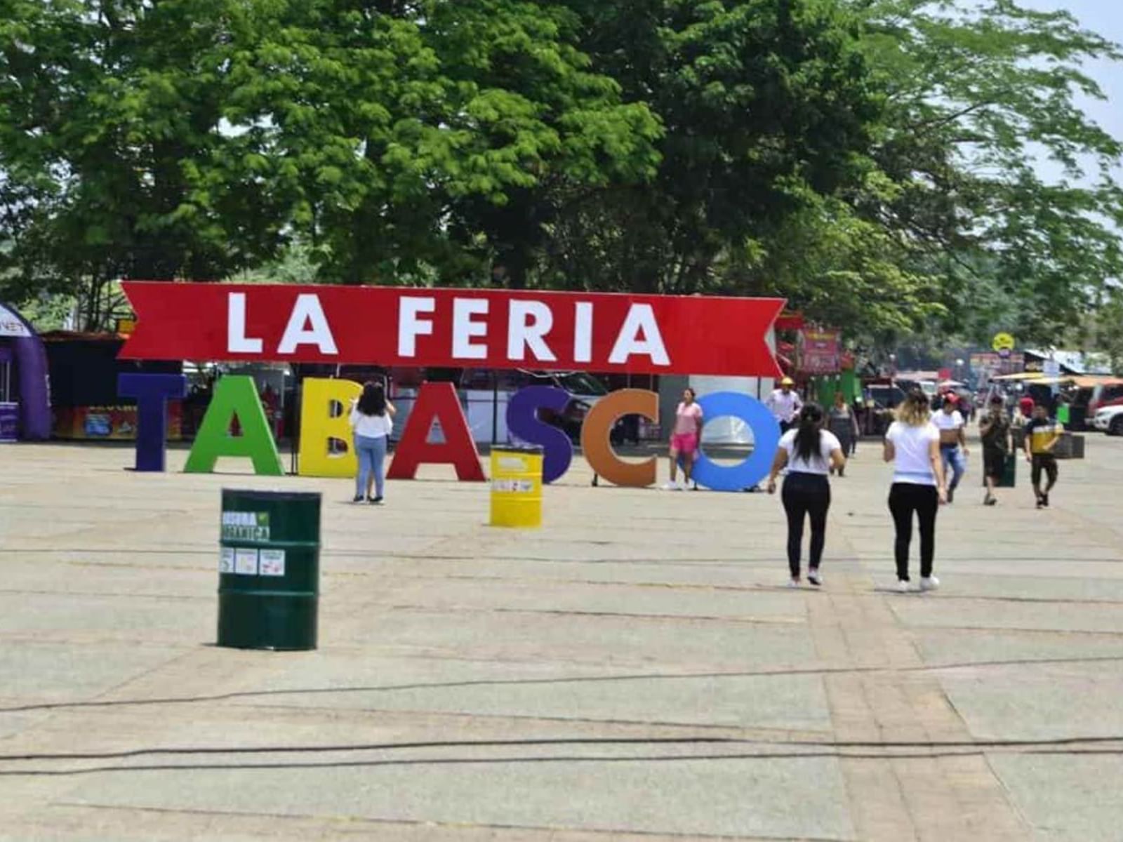 Display La Feria Tabasco sign and people walking in fair near Gamma Hotels