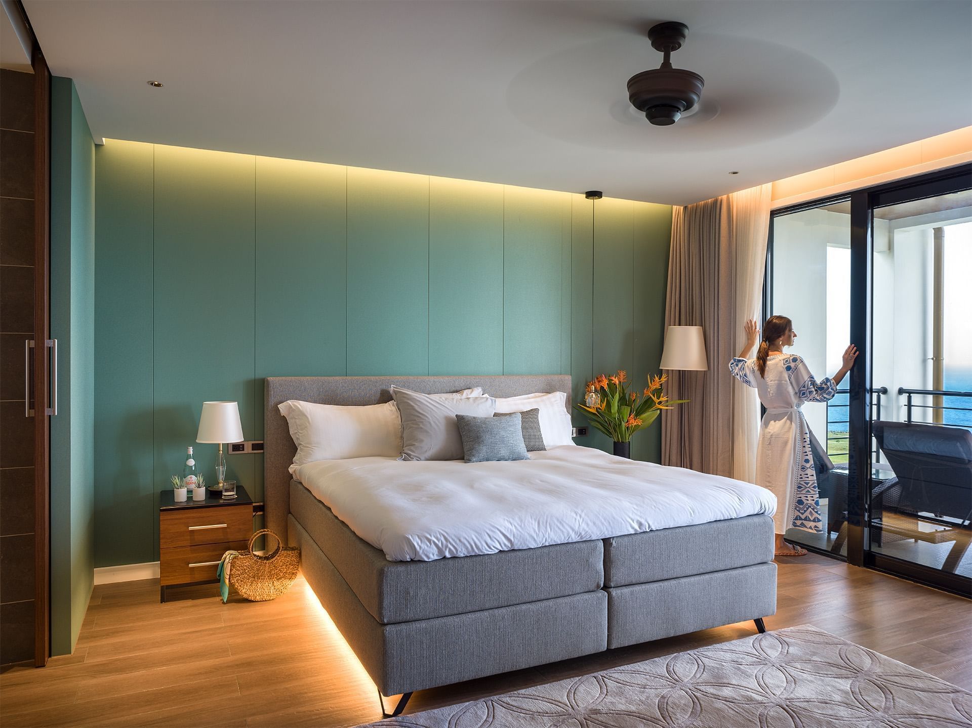 A lady by the balcony door, Deluxe Rooms at Golden Rock Resort