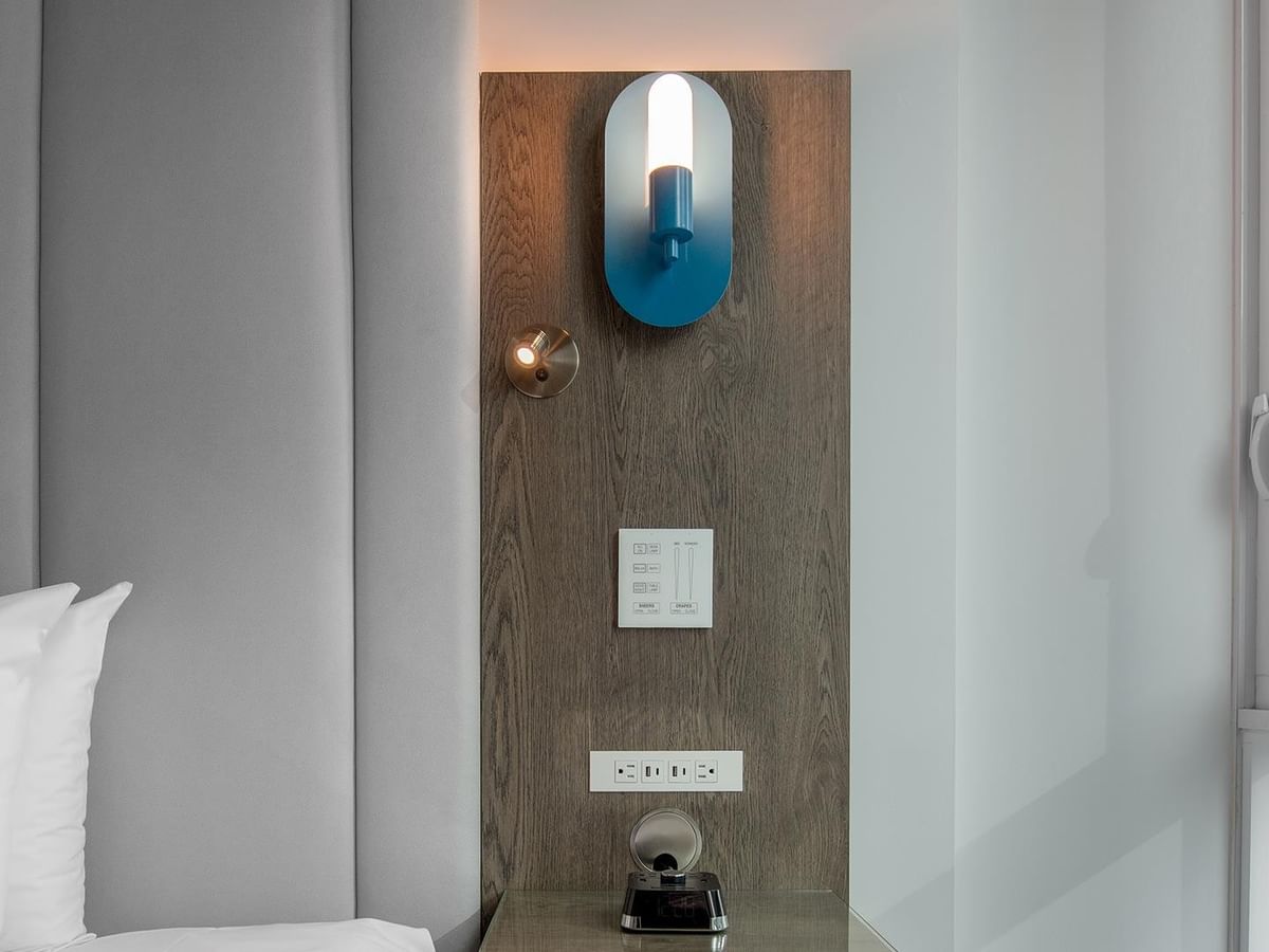 Room with modern bed and decorative lighting.