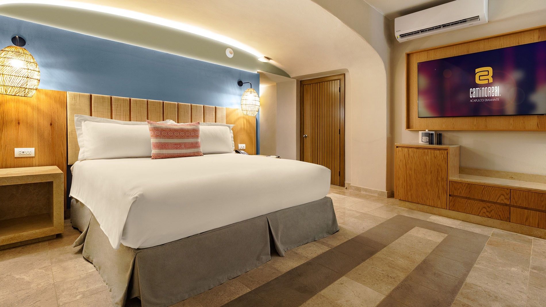 Ocean View King Deluxe Superior Room with blue wall, flat screen TV, & wooden media console at Camino Real Acapulco Diamante