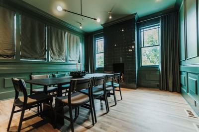 Dining area with long table set up in The Restaurant at The Stonebreaker Hotel
