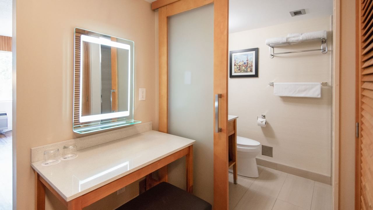 Hotel bathroom with mirror, toilet and towels