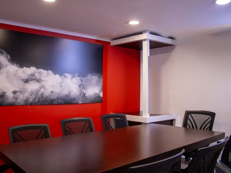 Meeting room table with office chairs & wall art in Gamma Puebla Señorial Centro