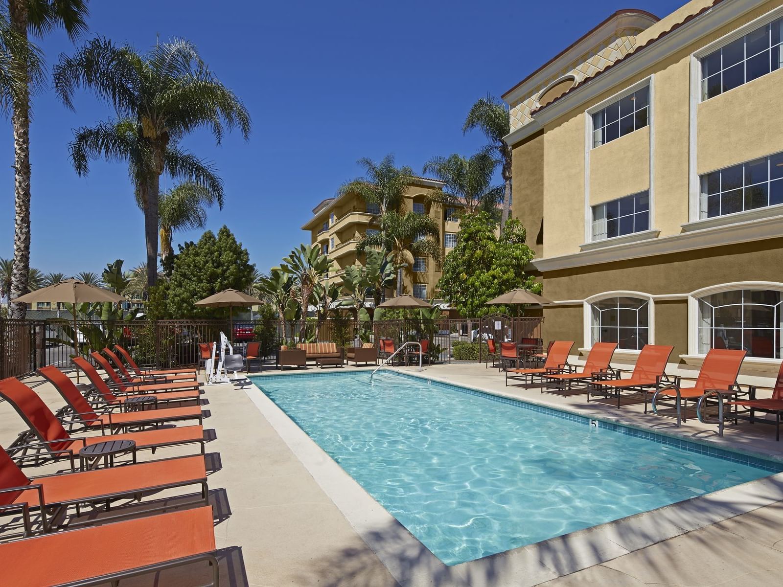Outdoor pool area with pool beds at Anaheim Portofino Inn