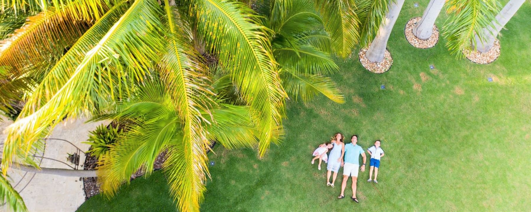 Family laying on the ground at the garden in Somerset Grace Bay