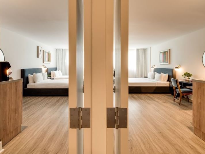 View through open double doors into two modern connecting Two Bedroom Family Room at Kenmore Village Hotel South Beach