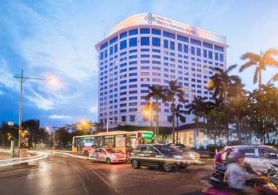 Exterior view of Hanoi Daewoo Hotel with heavy traffic