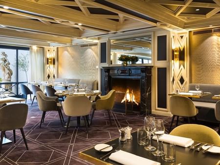 Fireplace by dining area in The Avenue Restaurant at Hotel Barsey by Warwick - Brussels