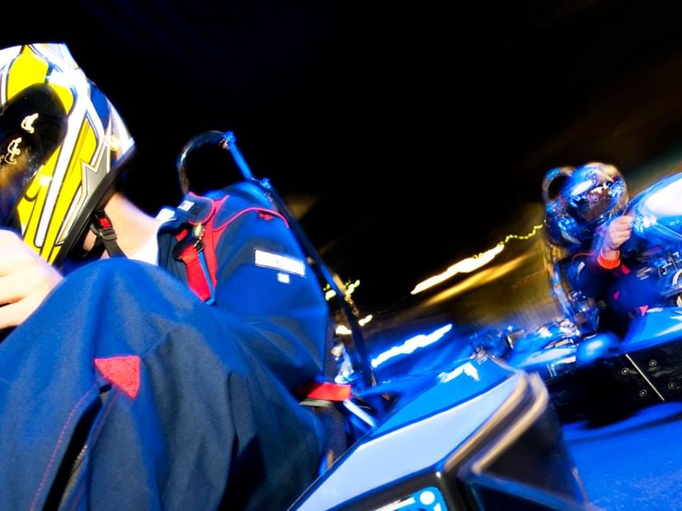 Close-up view of race car driver in Andretti Indoor Karting & Games at Lake Buena Vista Resort Village & Spa