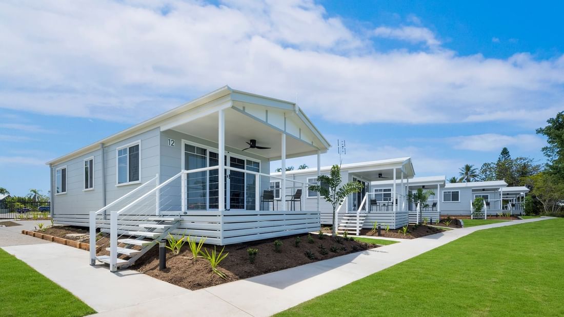 Deluxe Bungalow 2 Bedroom with white railings and porches, surrounded by greenery at Mercure Hotel Townsville