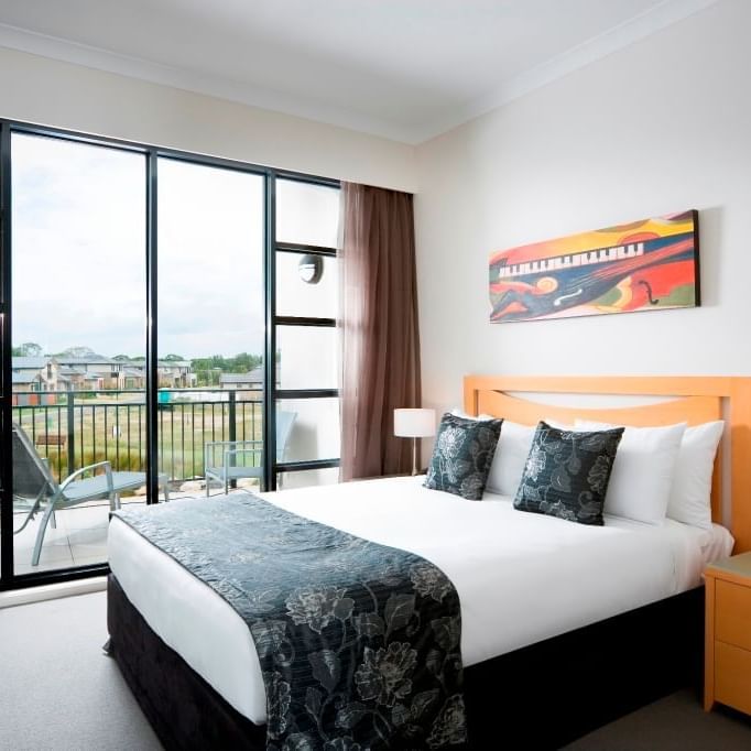 comfortable bed and bed table room seetings at Mercure Kooindah Waters