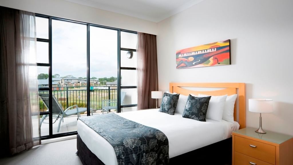 comfortable bed and bed table room seetings at Mercure Kooindah Waters