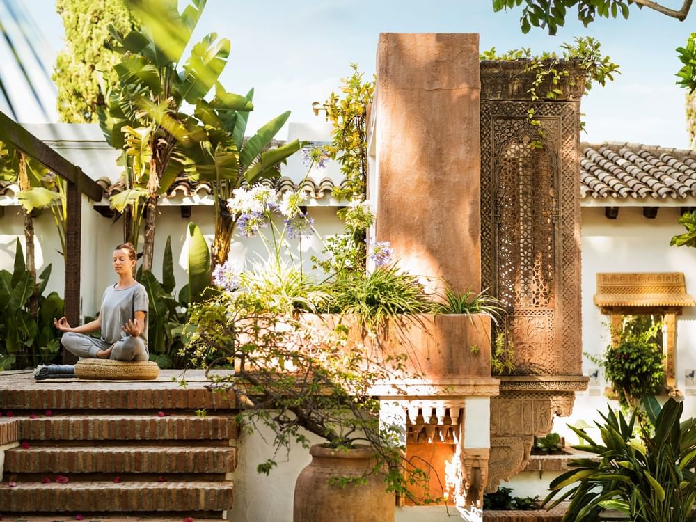 A lady meditating in the garden at Marbella Club Hotel