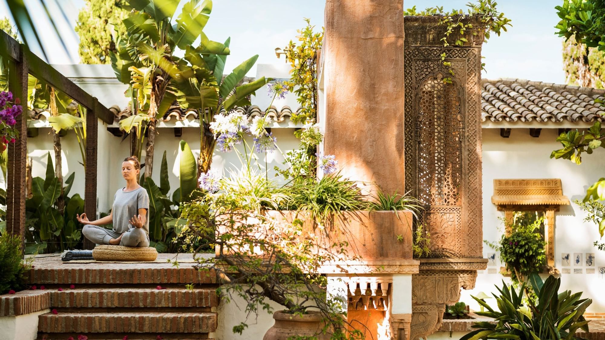 A lady meditating in the garden at Marbella Club Hotel