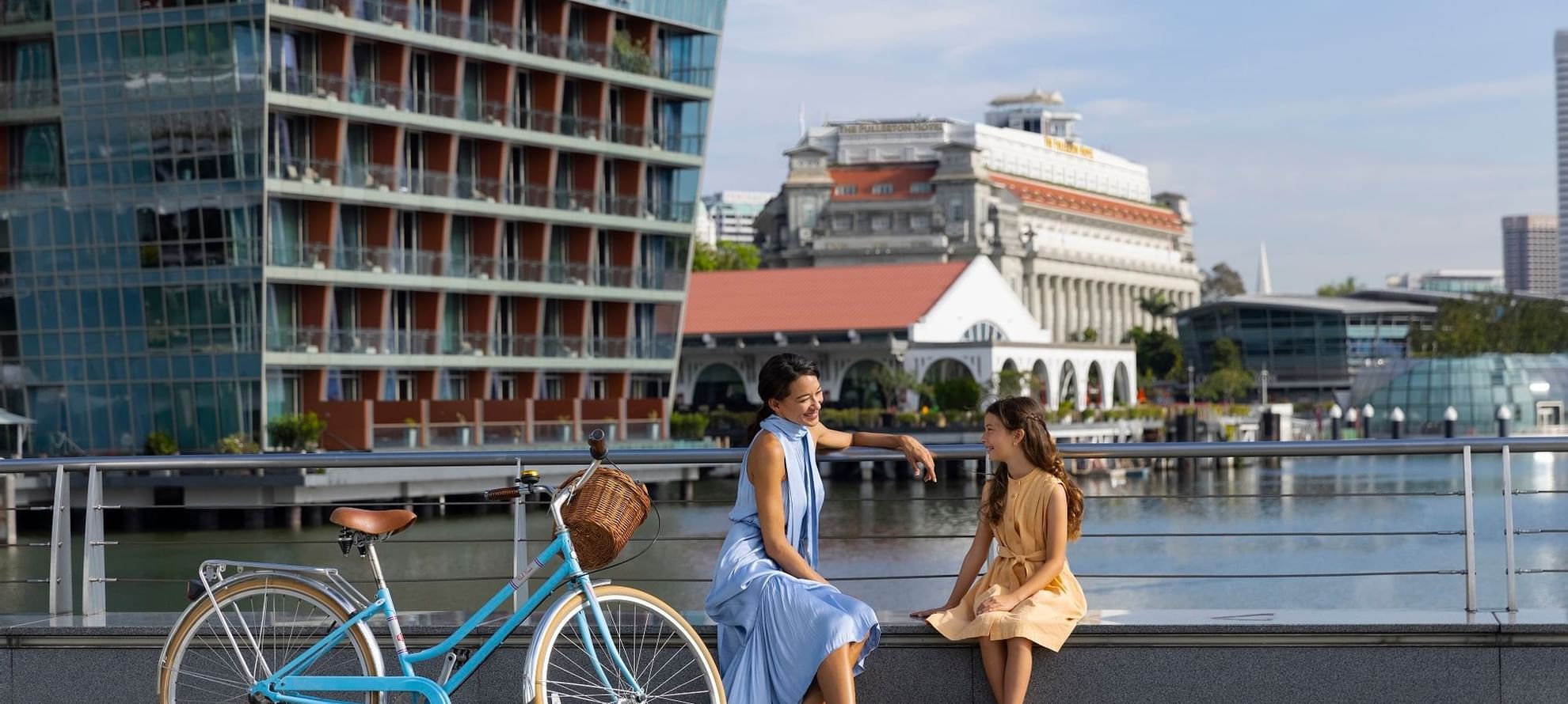 Lady & girl talking by exterior view at Fullerton Bay Singapore