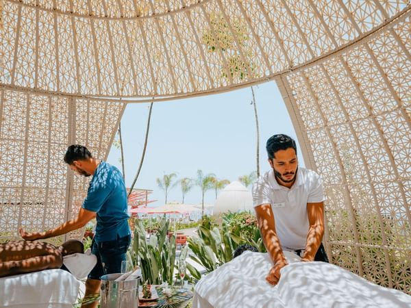 Man enjoying a relaxing massage inside a cabana at Almar Beach Resort