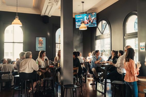 People lounging & having drinks in De Baun & Co. Pub at Melbourne Hotel Perth