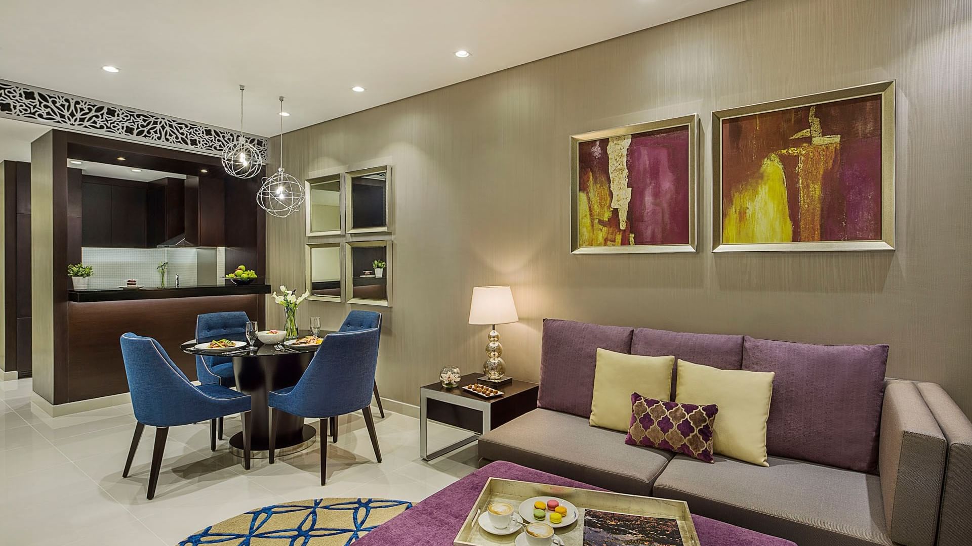 Spacious living area with dining table by the kitchenette in One Bedroom Suite at DAMAC Maison Distinction