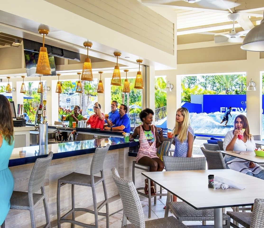 People enjoying drinks in Longboard Bar & Grill at The Grove Resort & Water Park