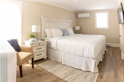 Wall-mounted TV and seating area by the bed in Robins House with welcoming accommodation in Yarmouth at Rodd Grand Yarmouth