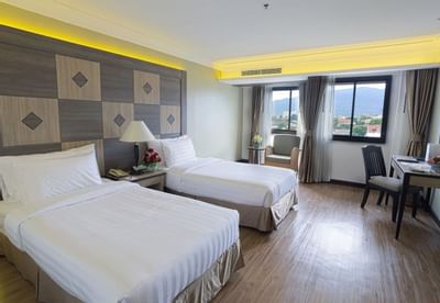 Cozy beds with desk in Superior Room at Amora Hotel Chiang Mai