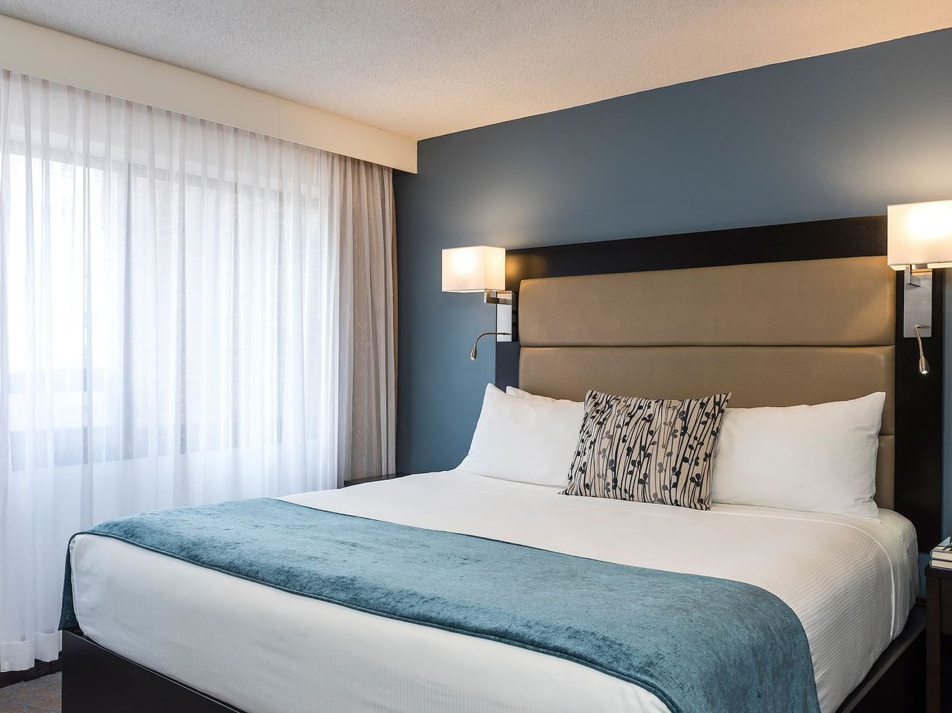 room with bed and wall lamps