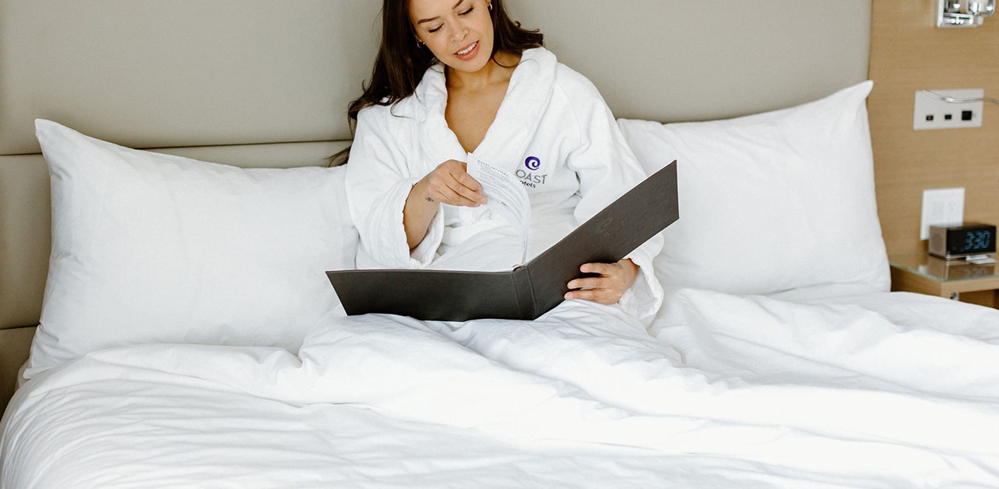 Ordering room service in bed at Coast Tsawwassen Inn