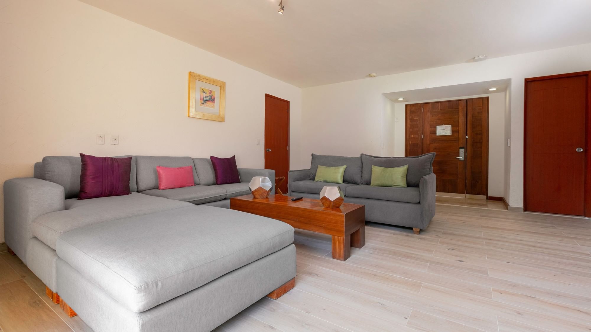 Gray couch with colorful pillows in the King Viceroys Suite at Camino Real Guadalajara, Zapopan