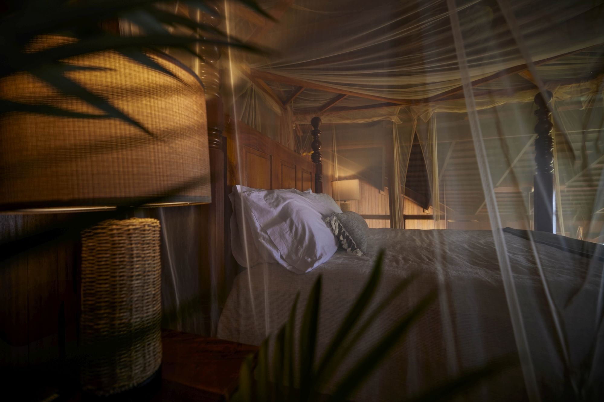 Comfy bed covered with a net in Heritage Suites, accommodation St Lucia