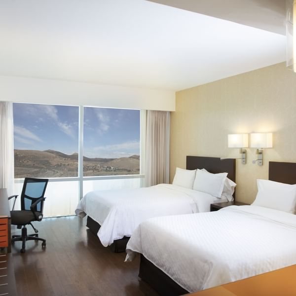 Twin beds in Superior Room with city view at Fiesta Inn