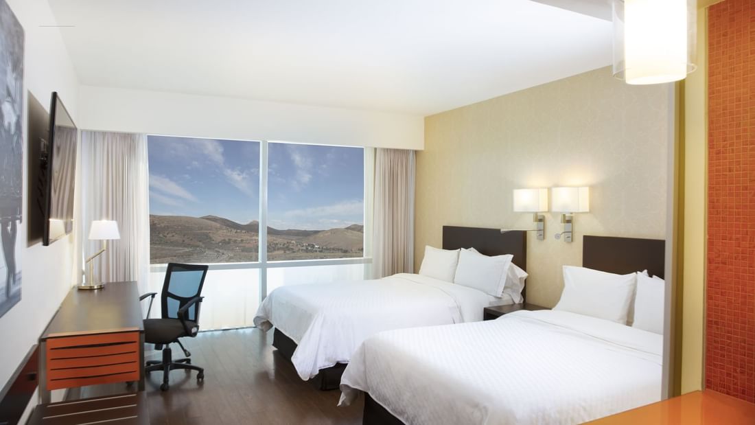 Twin beds in Superior Room with city view at Fiesta Inn