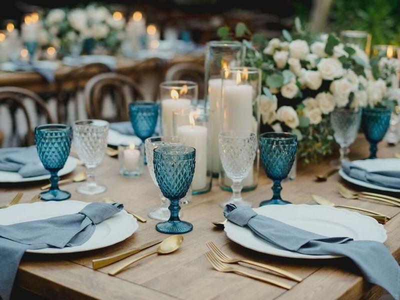 Dining set up with candle decors at a wedding in Gamma Hotels