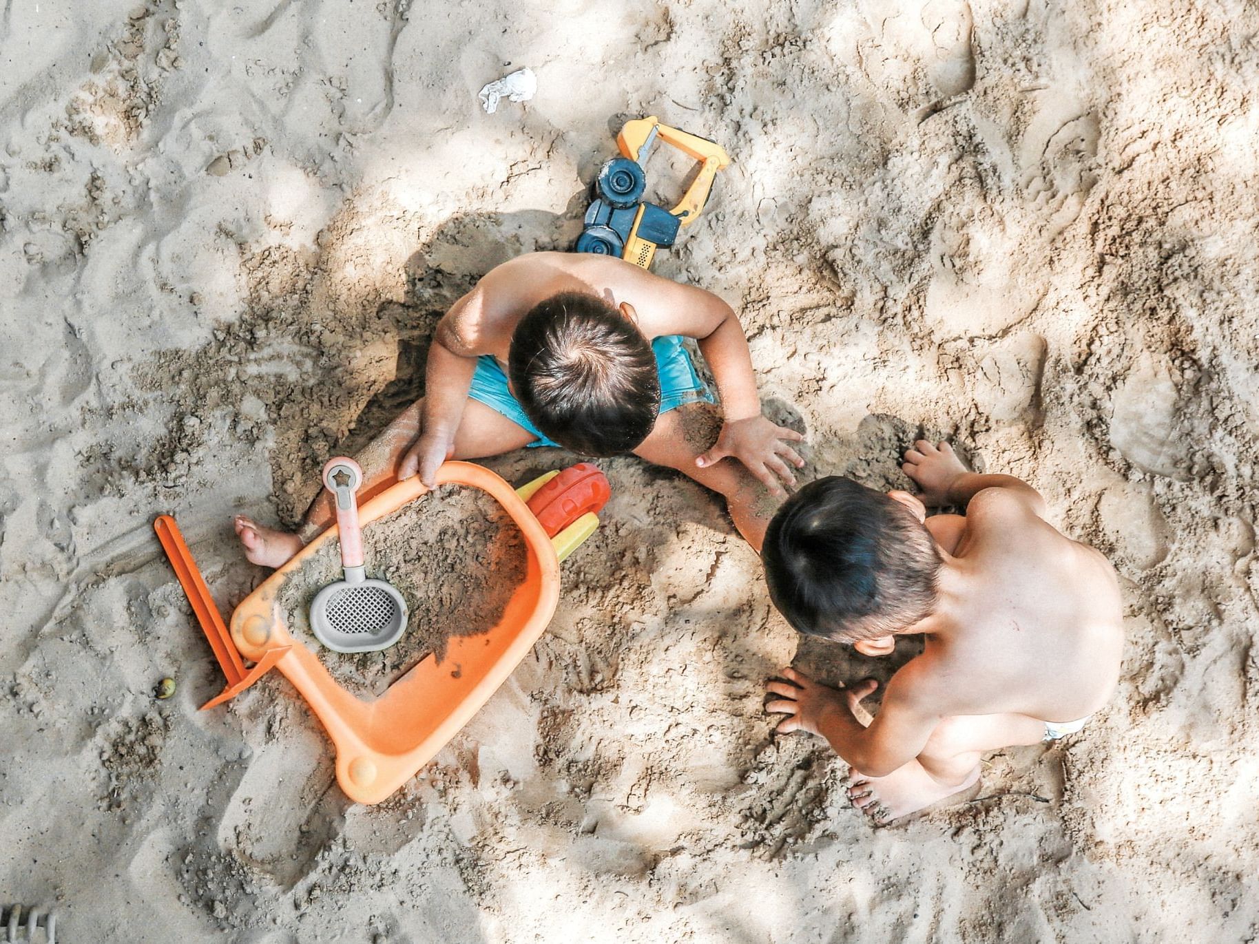 2 boys playing with sand at Villas Sol Beach Resort