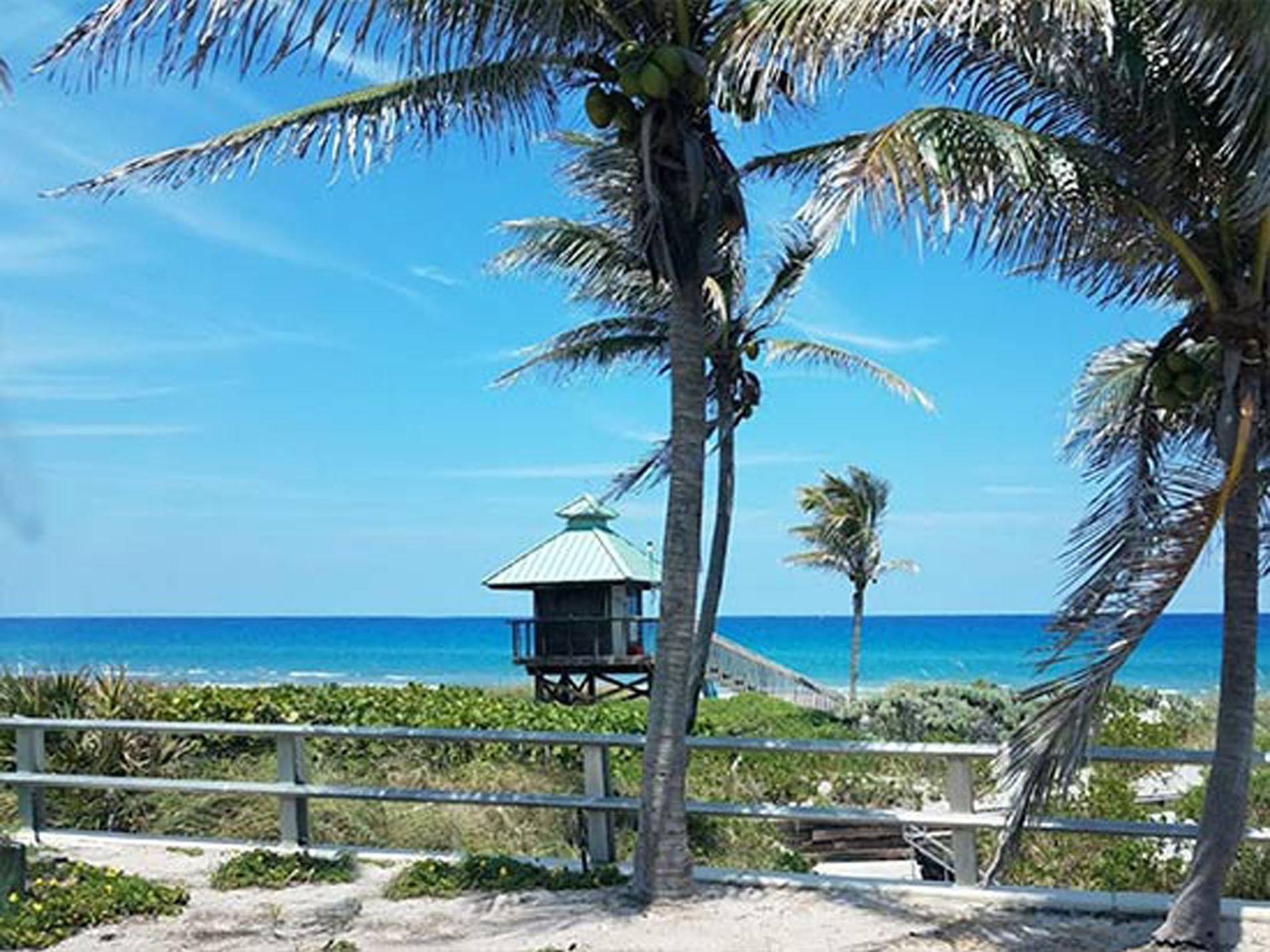 Ocean view from a sandy beach on a sunny day in Spanish River Park near Ocean Lodge Boca Raton 