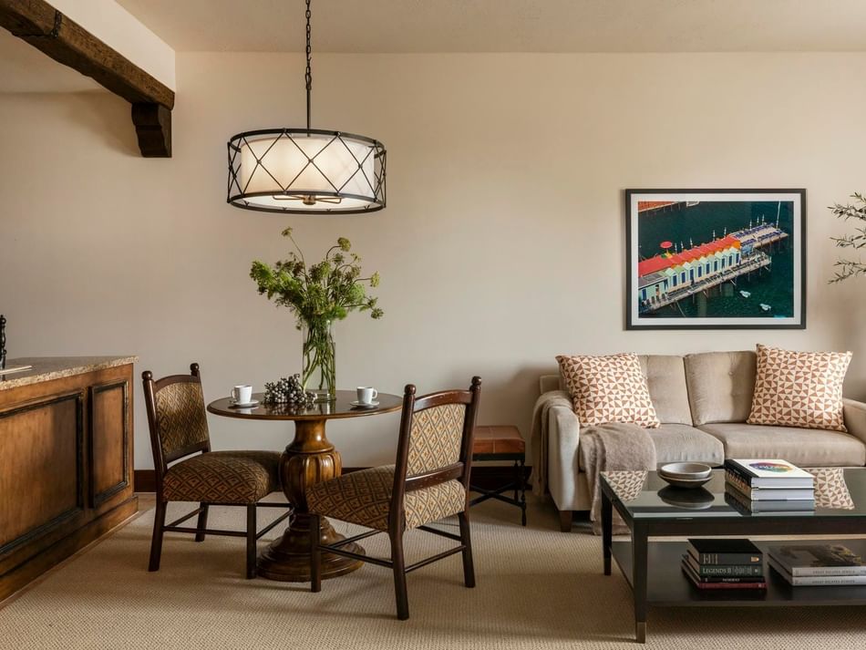Presidential Suite living area featuring plush seating and a dining table at Granduca Houston