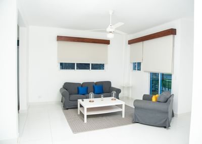 Spacious living area with a comfy sofa in Two-Bedroom Suite at Cha Cha Hotel