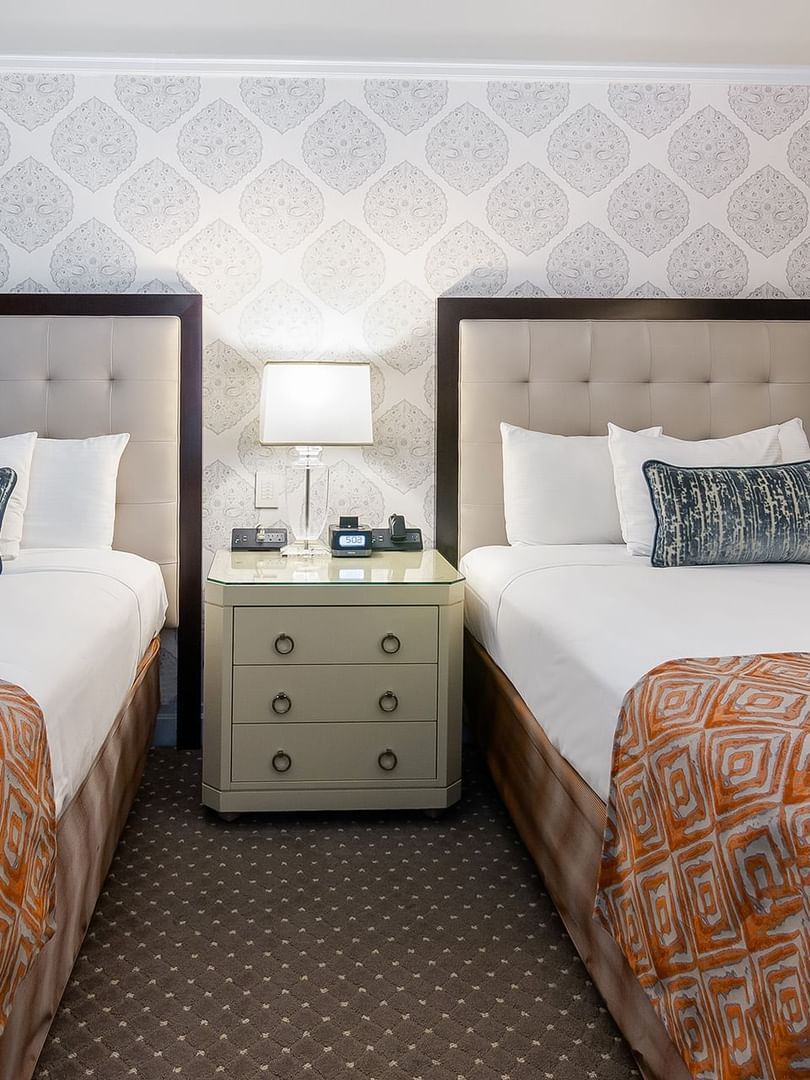 Two beds with a side table in Premier City View 2 Double Beds at Warwick New York