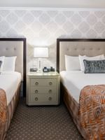 Two beds with a side table in Premier City View 2 Double Beds at Warwick New York