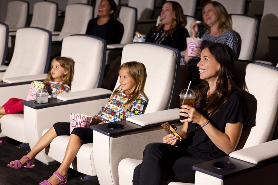 People enjoying beverages while watching a movie in the cinema at Hotel X Toronto
