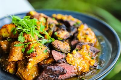 Savory roasted meat served on a dark plate in Boathouse at the Riverside Hotel Fort Lauderdale