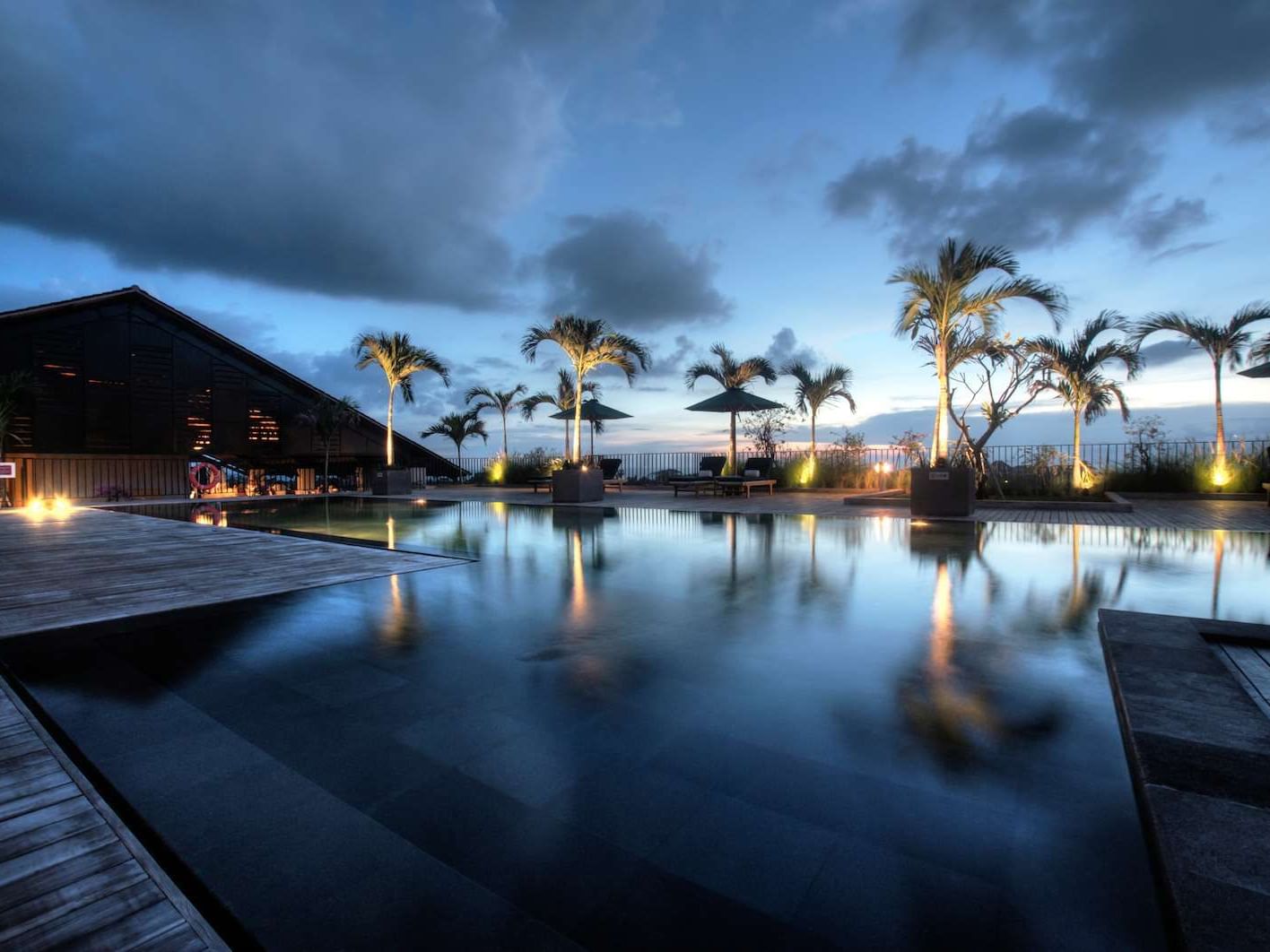 Outdoor Pool and palm trees of U Paasha Seminyak Bali Hotel